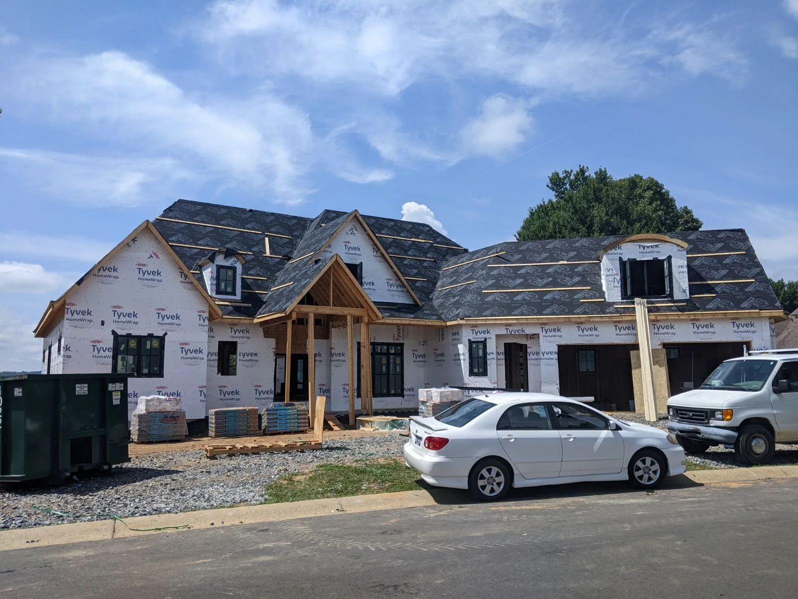 Large home under construction with roof work in progress