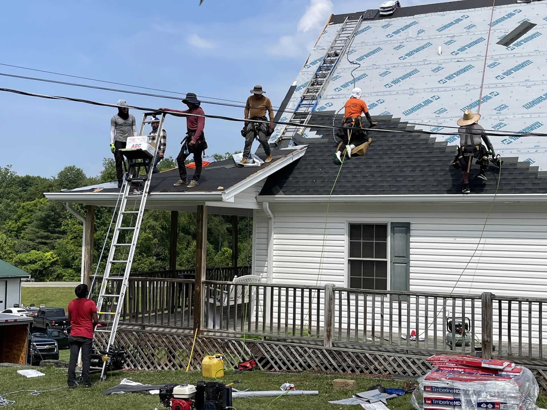 Roofing crew installing underlayment on a home